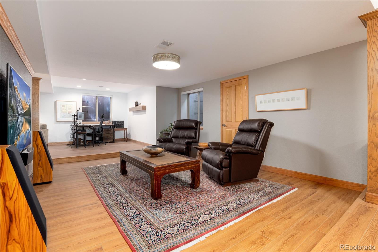 65 North Ranch Road Littleton, CO 80127 - Photo 25 of 44 a living room with furniture and a flat screen tv