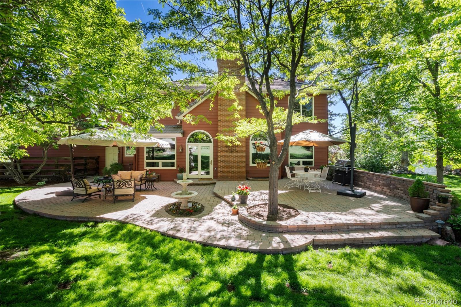 65 North Ranch Road Littleton, CO 80127 - Photo 3 of 44 a view of a patio with table and chairs potted plants and large tree