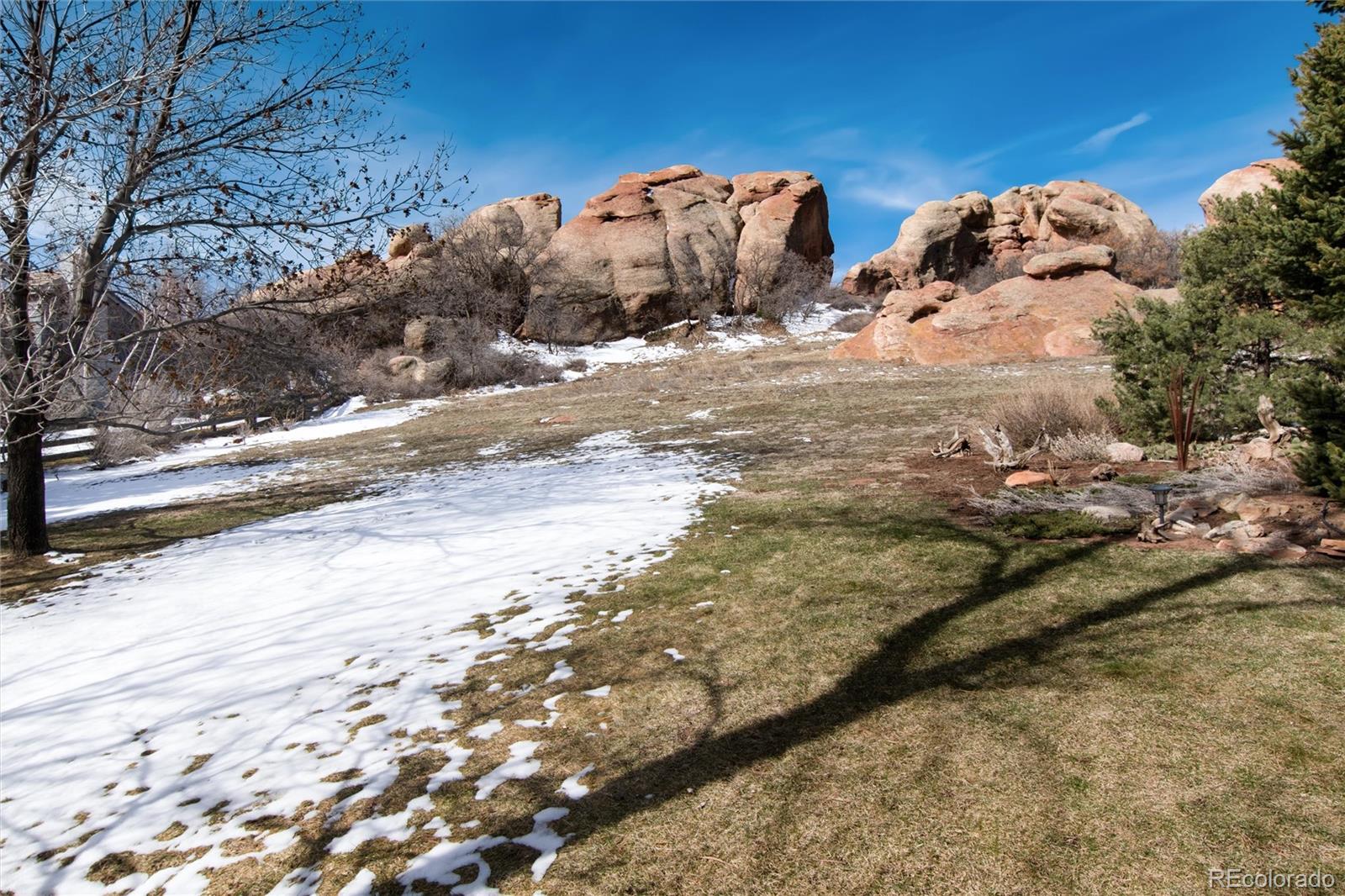 65 North Ranch Road Littleton, CO 80127 - Photo 32 of 44 a view of a dry yard with wooden fence