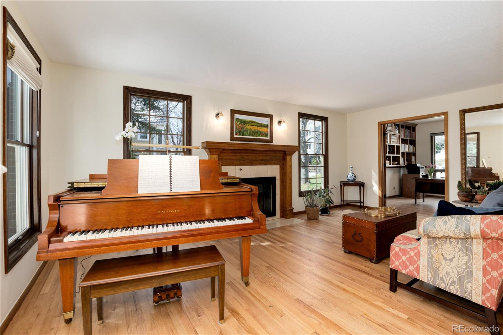 65 North Ranch Road Littleton, CO 80127 - Photo 36 of 44 a living room with furniture a fireplace and a flat screen tv