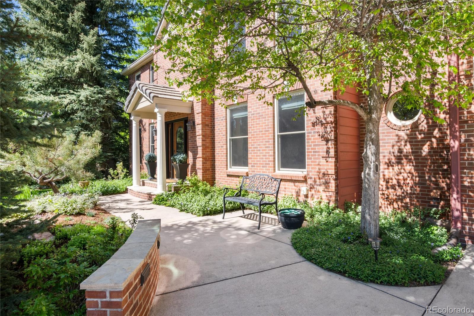 65 North Ranch Road Littleton, CO 80127 - Photo 39 of 44 a front view of a house with garden and trees