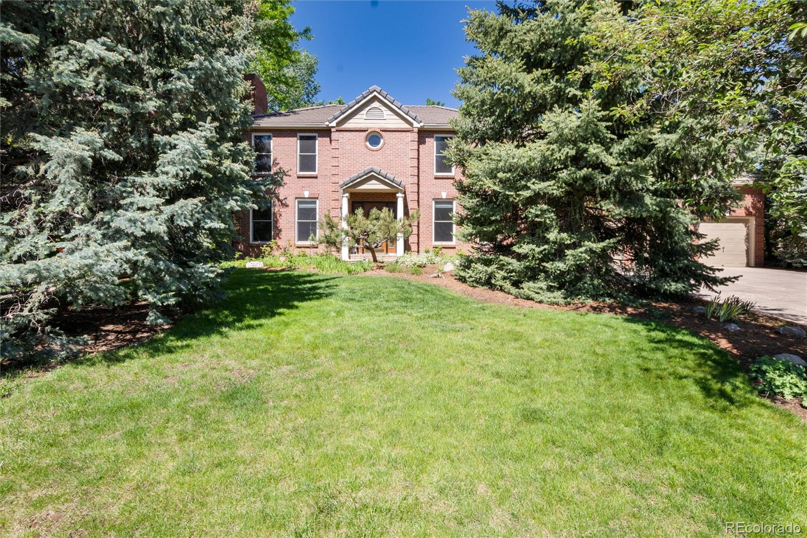 65 North Ranch Road Littleton, CO 80127 - Photo 40 of 44 a front view of a house with a yard