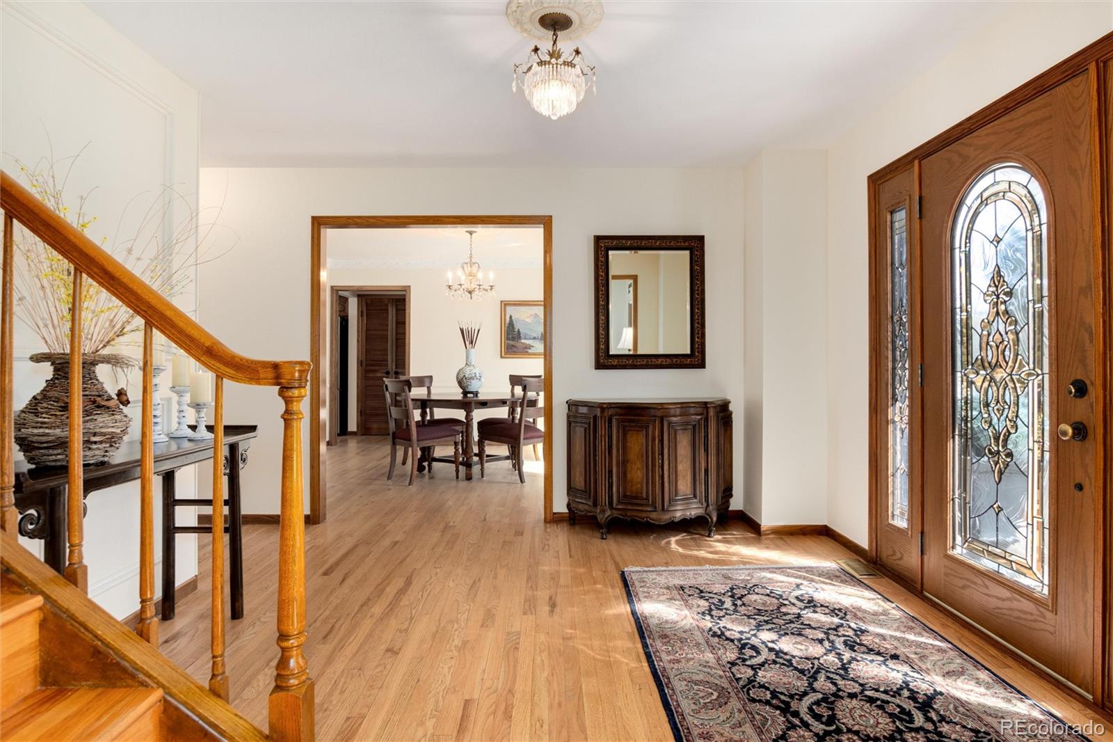 65 North Ranch Road Littleton, CO 80127 - Photo 4 of 44 a view of a hallway with wooden floor and staircase