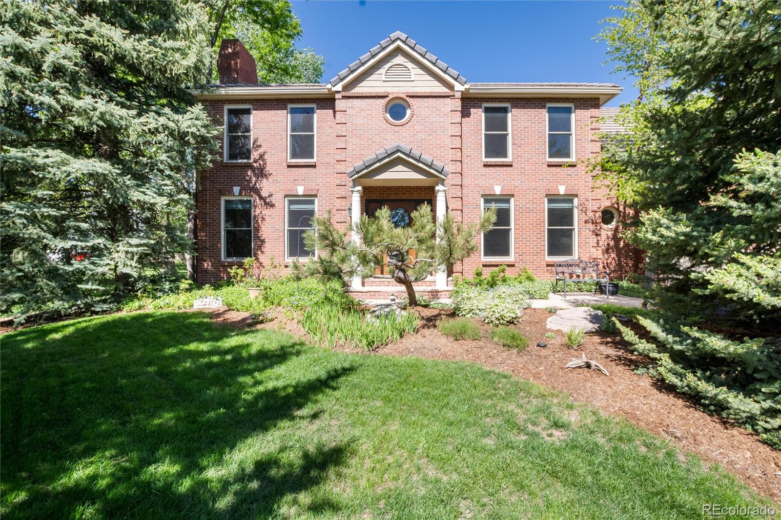 65 North Ranch Road Littleton, CO 80127 - Photo 41 of 44 a front view of a house with a garden