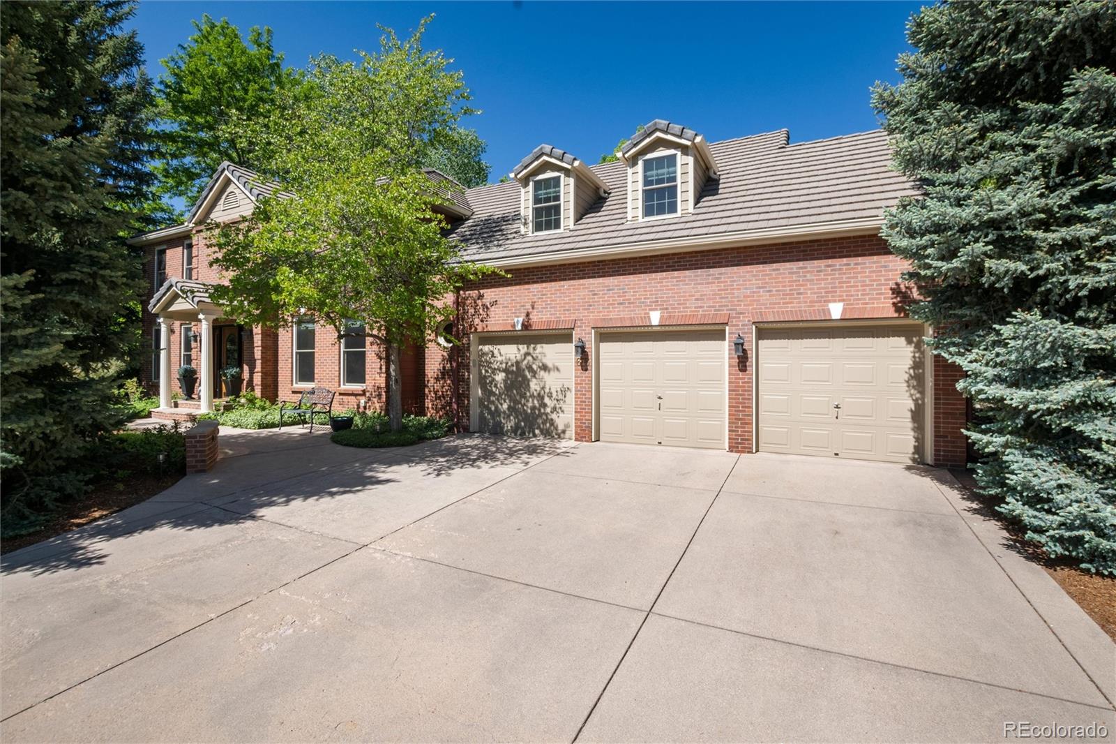 65 North Ranch Road Littleton, CO 80127 - Photo 42 of 44 a front view of a house with a yard and garage