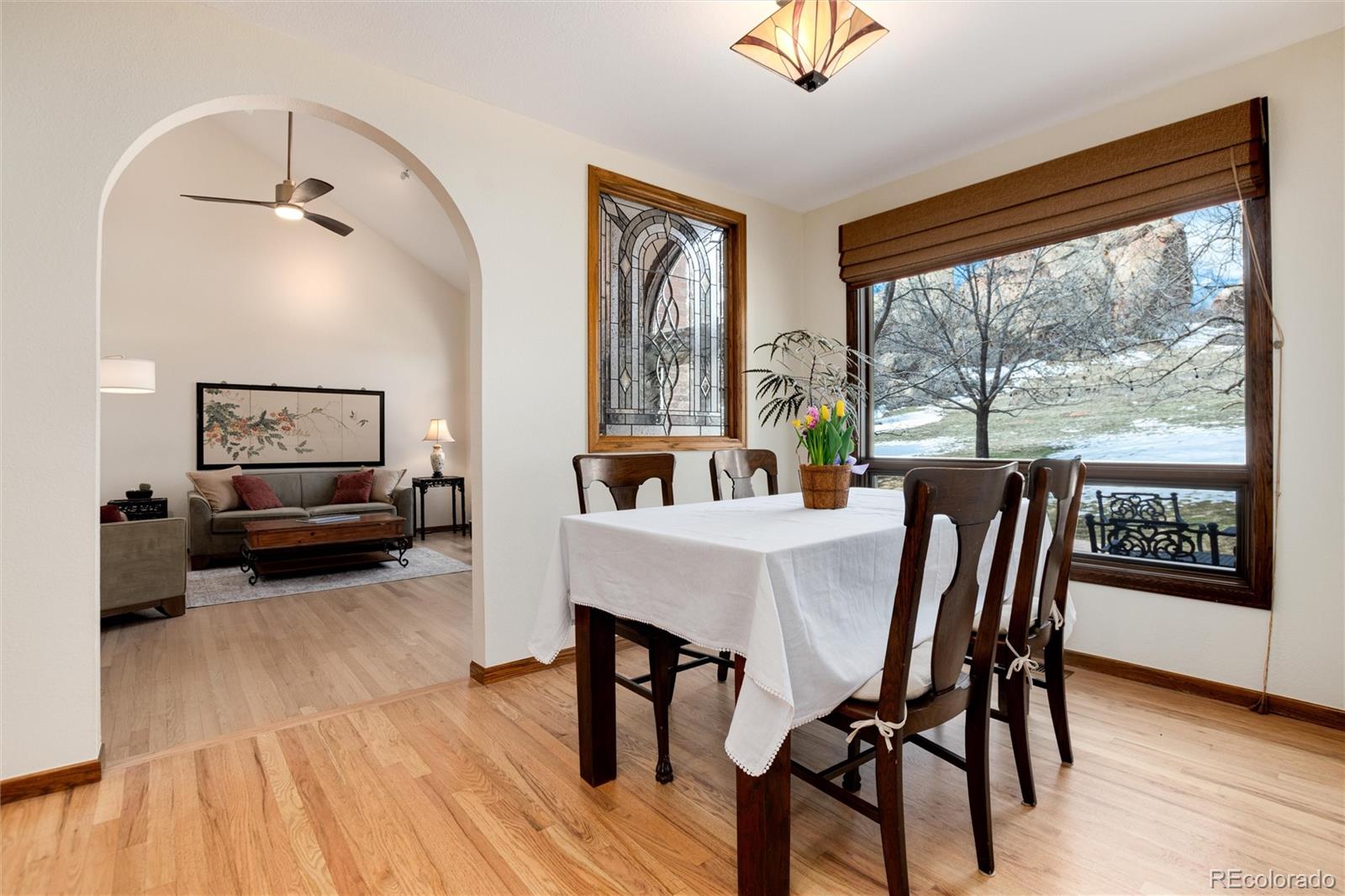 65 North Ranch Road Littleton, CO 80127 - Photo 7 of 44 a view of a dining room with furniture window and wooden floor