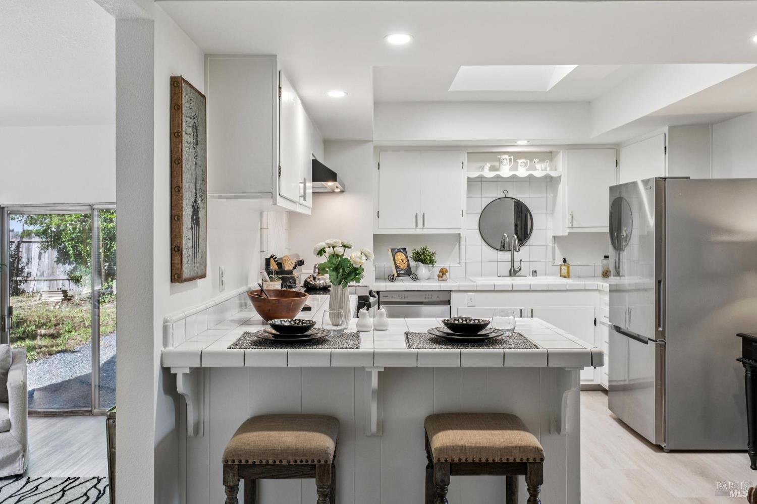 2295 Francisco Avenue, Unit 1 Santa Rosa, CA 95403 - Photo 16 of 65 a kitchen with stainless steel appliances a dining table chairs refrigerator and sink
