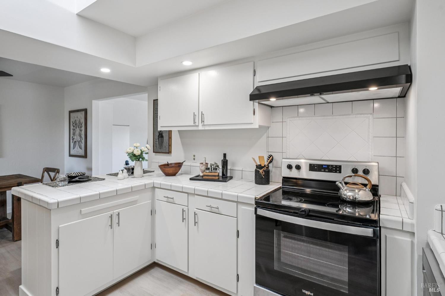 2295 Francisco Avenue, Unit 1 Santa Rosa, CA 95403 - Photo 18 of 65 a kitchen with white cabinets and appliances