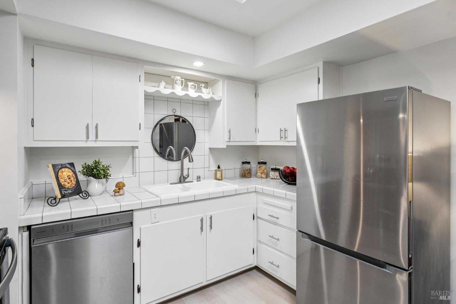 2295 Francisco Avenue, Unit 1 Santa Rosa, CA 95403 - Photo 19 of 65 a kitchen with a refrigerator sink and cabinets
