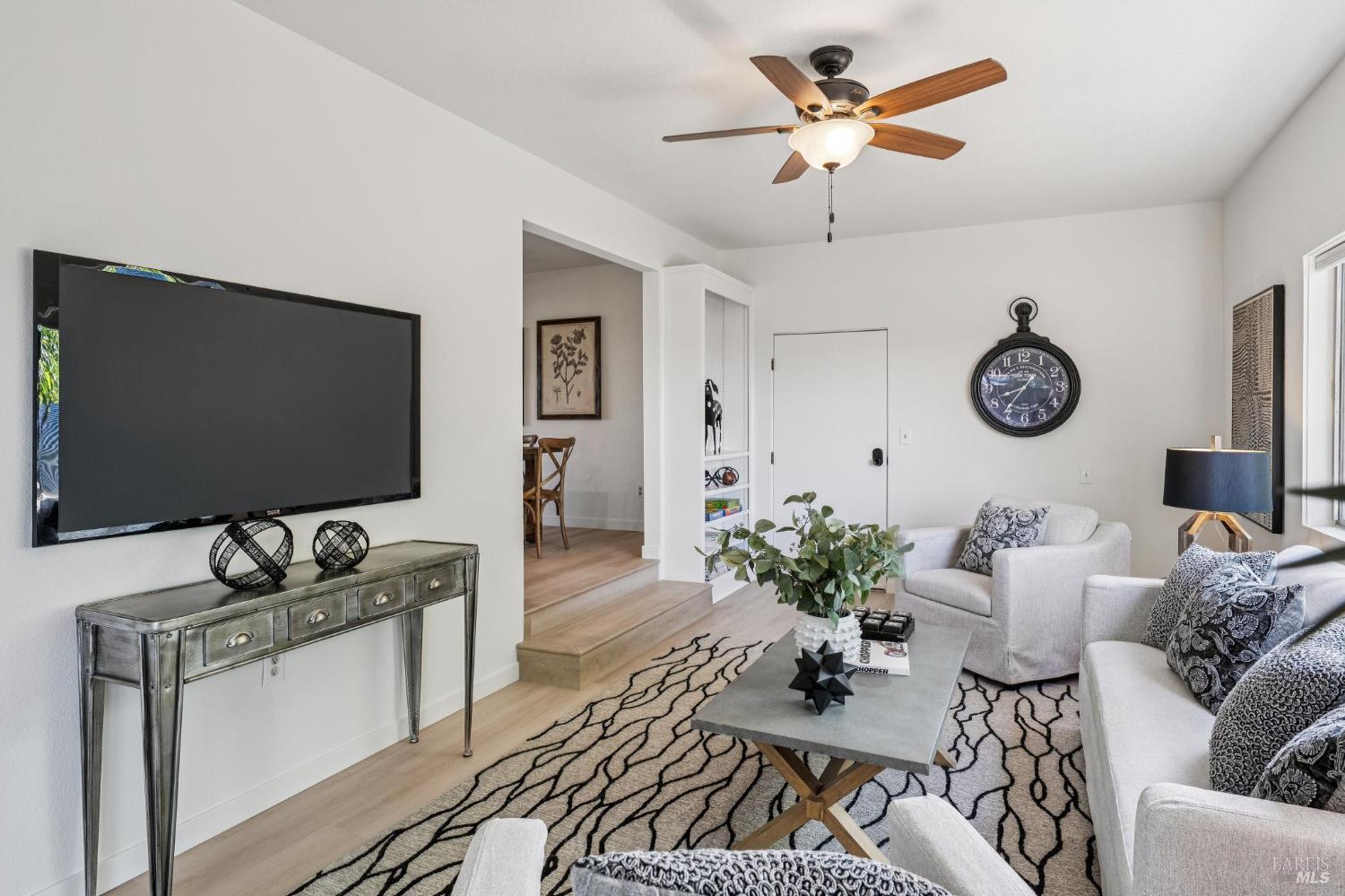 2295 Francisco Avenue, Unit 1 Santa Rosa, CA 95403 - Photo 22 of 65 a living room with furniture a chandelier and a flat screen tv