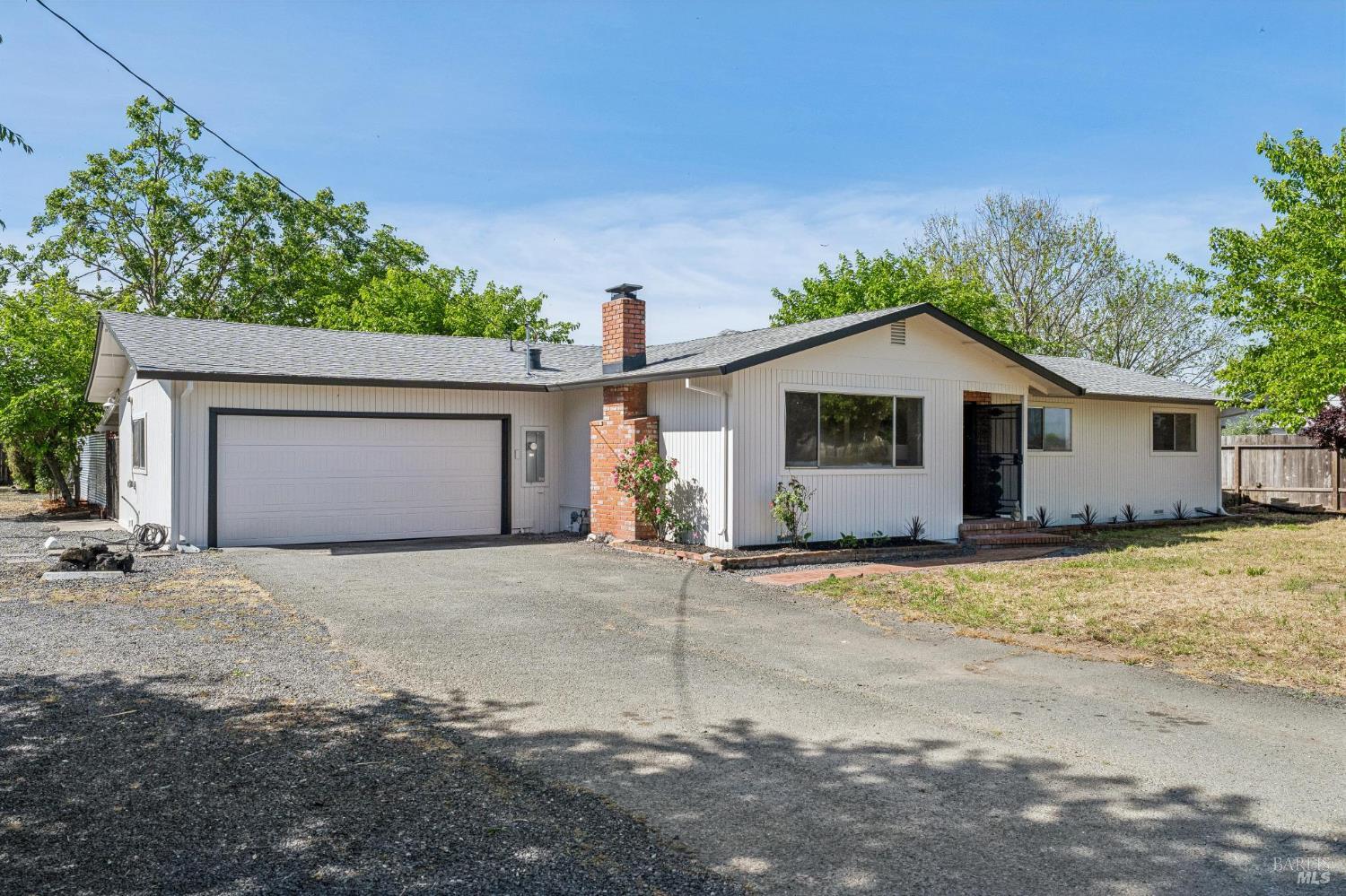 2295 Francisco Avenue, Unit 1 Santa Rosa, CA 95403 - Photo 3 of 65 a view of a house with a yard and garage
