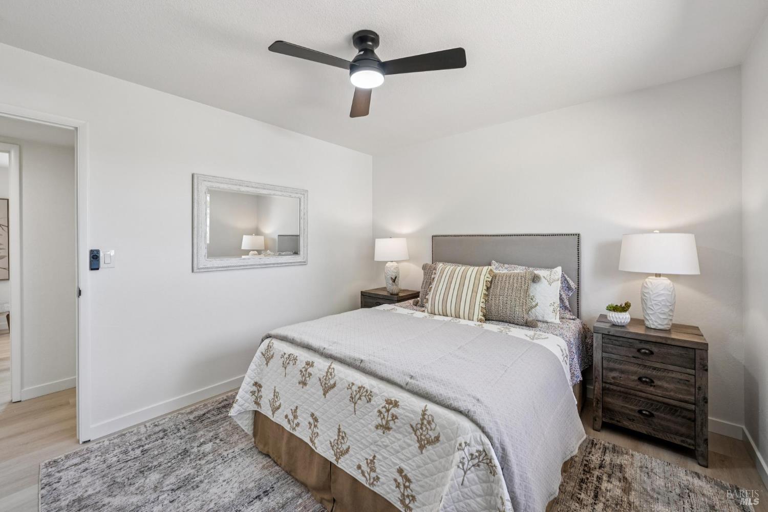 2295 Francisco Avenue, Unit 1 Santa Rosa, CA 95403 - Photo 32 of 65 a bedroom with a bed and a chandelier