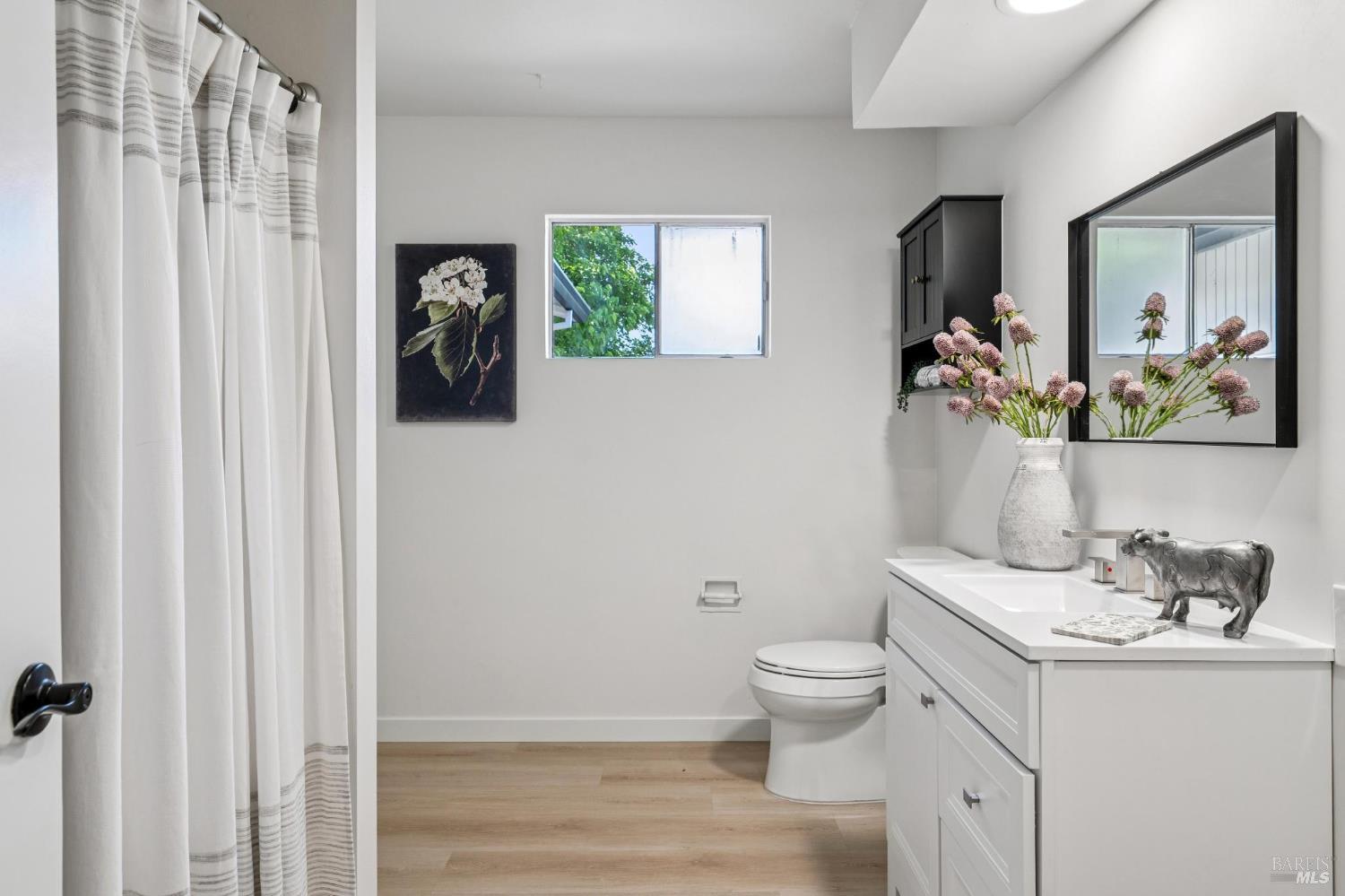 2295 Francisco Avenue, Unit 1 Santa Rosa, CA 95403 - Photo 34 of 65 a bathroom with a toilet a sink and a mirror