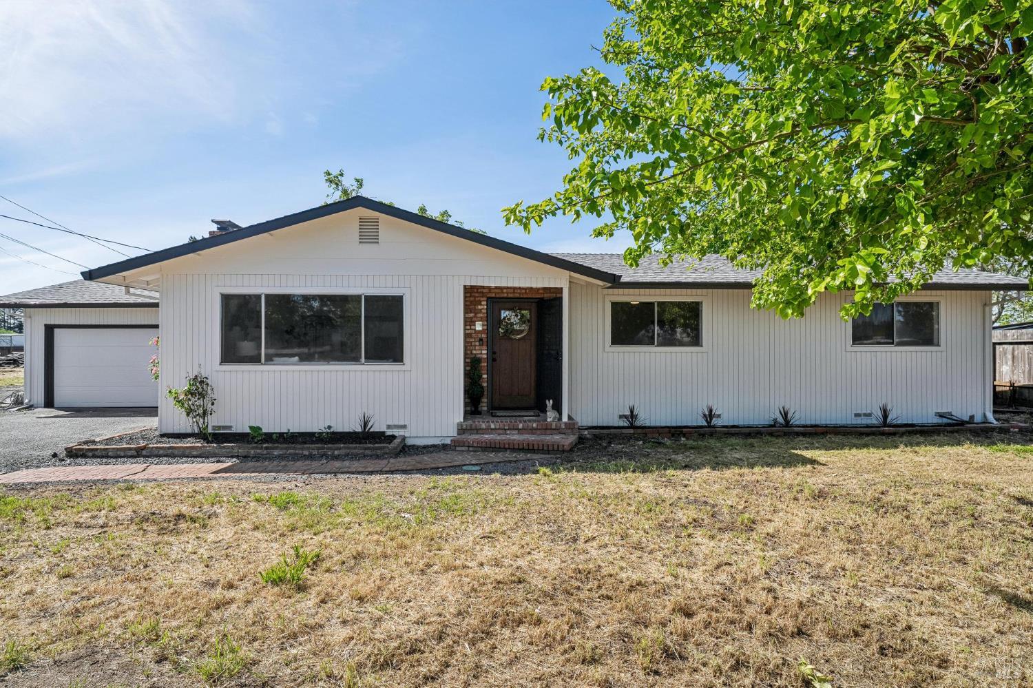 2295 Francisco Avenue, Unit 1 Santa Rosa, CA 95403 - Photo 4 of 65 a front view of a house with a yard