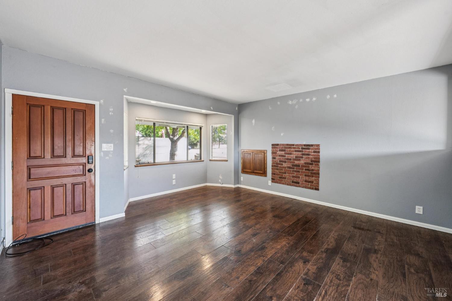 2295 Francisco Avenue, Unit 1 Santa Rosa, CA 95403 - Photo 49 of 65 a view of an empty room with a window and wooden floor
