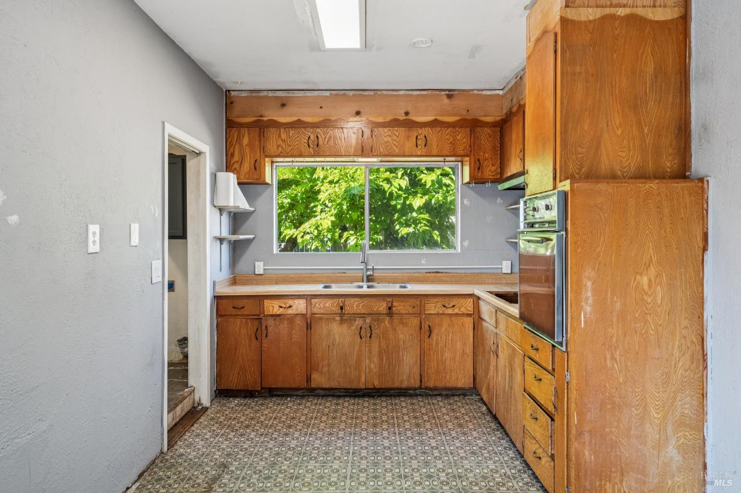 2295 Francisco Avenue, Unit 1 Santa Rosa, CA 95403 - Photo 50 of 65 a kitchen with stainless steel appliances granite countertop a sink and a refrigerator