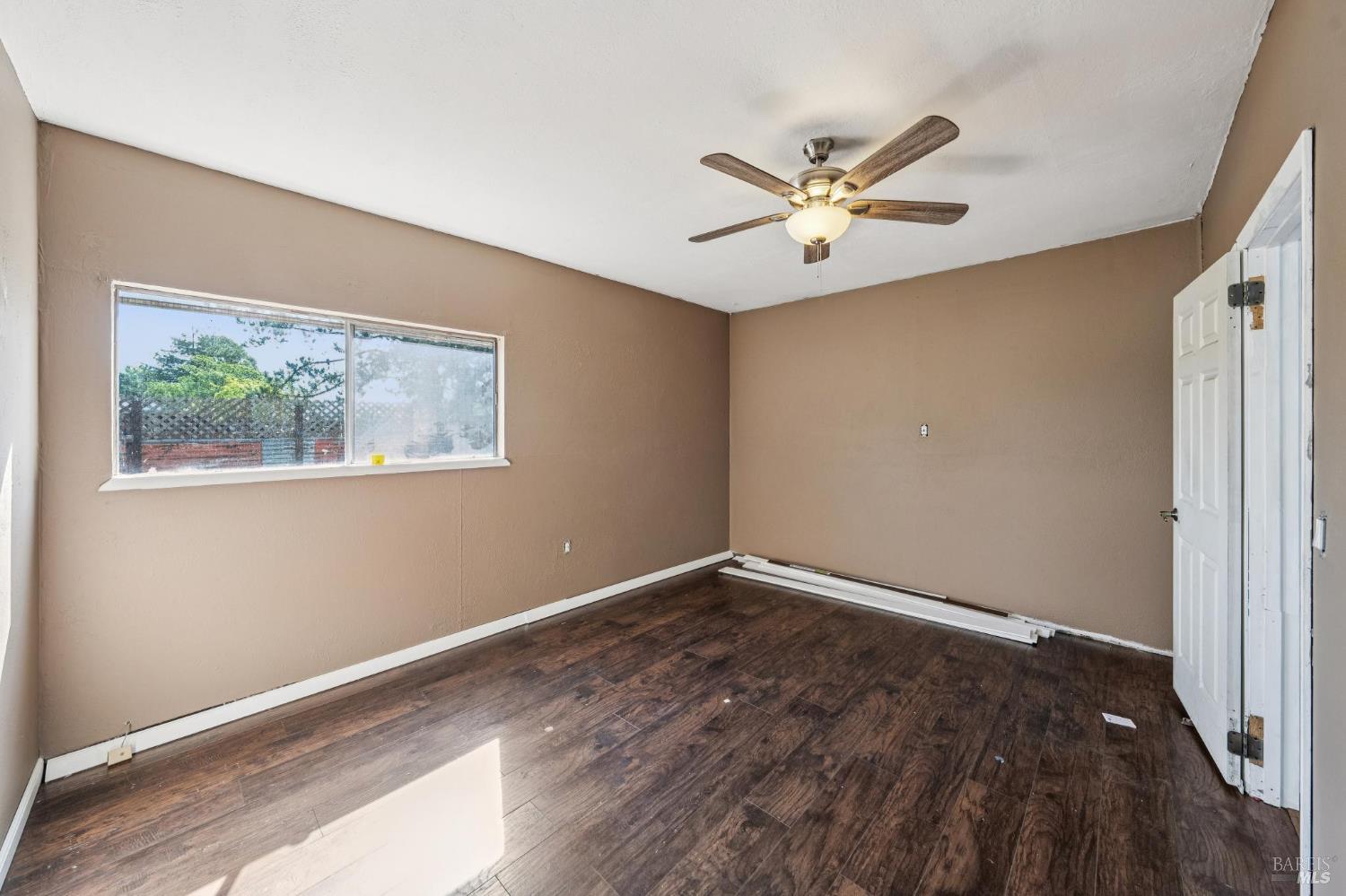 2295 Francisco Avenue, Unit 1 Santa Rosa, CA 95403 - Photo 54 of 65 a view of an empty room with window and wooden floor