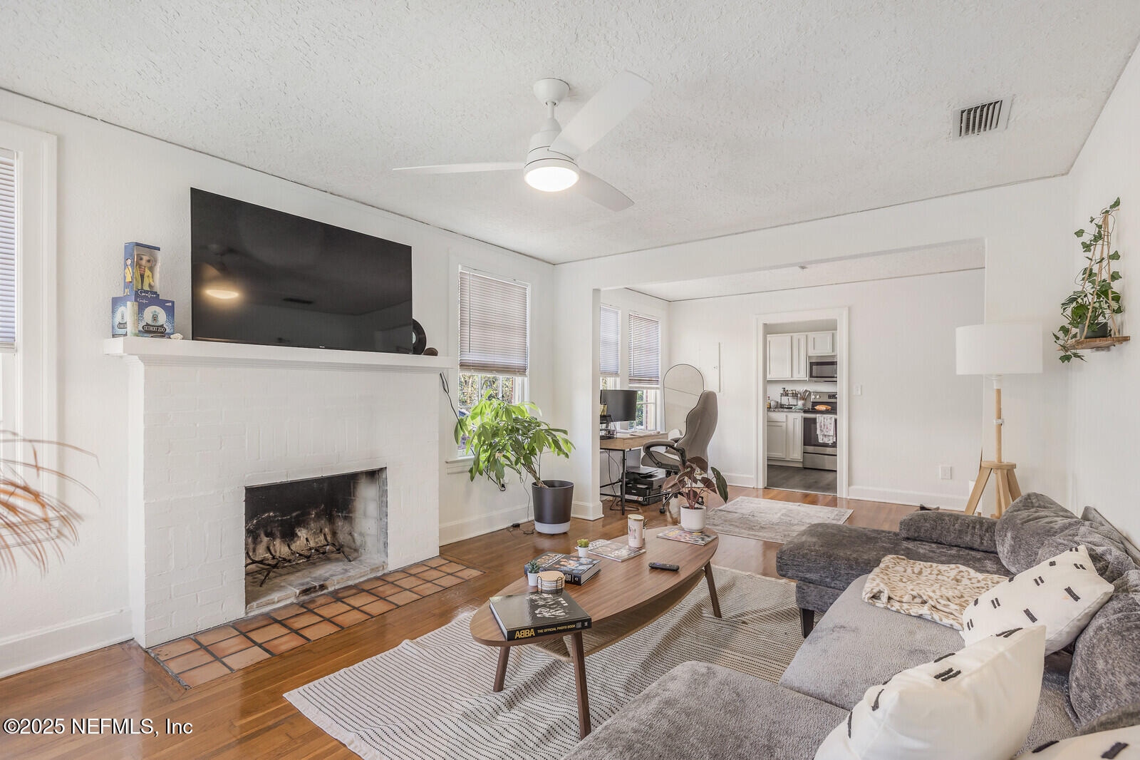 3668 Valencia Road Jacksonville, FL 32205 - Photo 7 of 23 a living room with furniture a flat screen tv and a fireplace