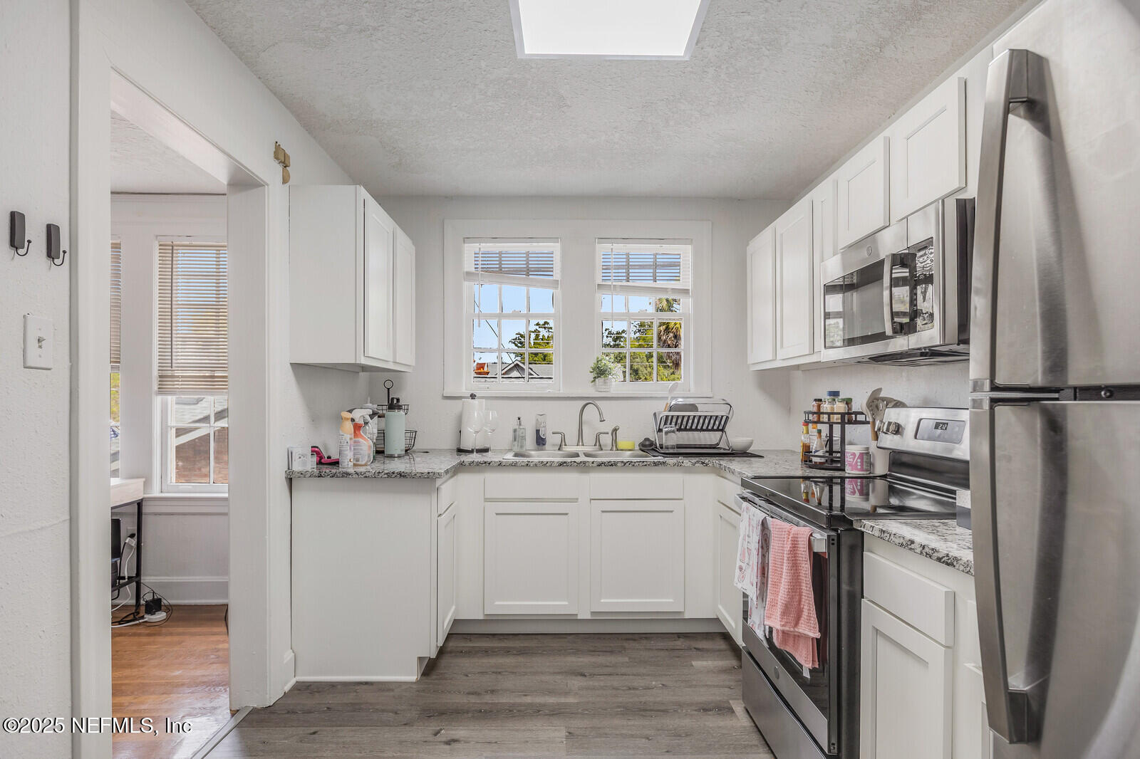 3668 Valencia Road Jacksonville, FL 32205 - Photo 10 of 23 a kitchen with stainless steel appliances granite countertop a sink stove refrigerator and cabinets