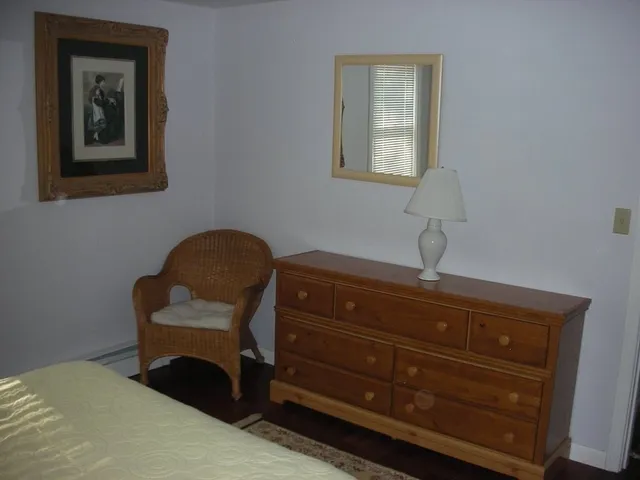 a room with a dresser and a window