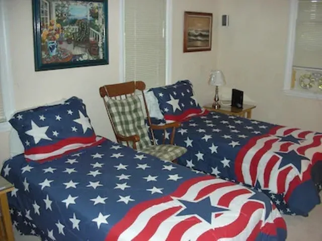 a bedroom with a bed and a painting on the wall