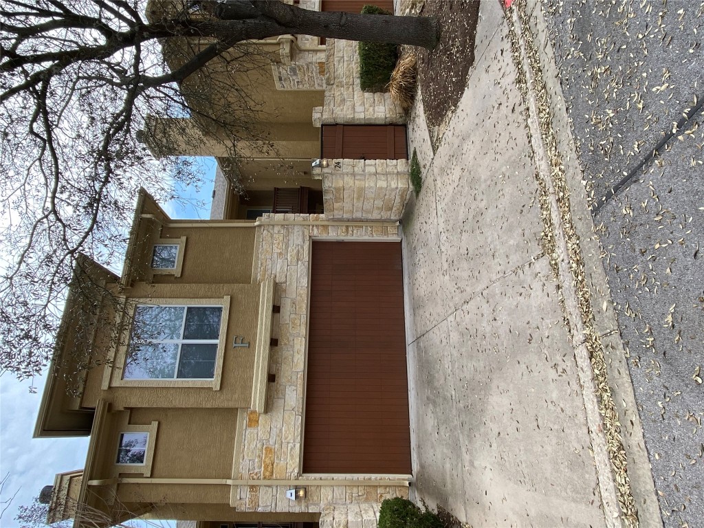 3406 Menchaca Road, Unit 24 Austin, TX 78704 - Photo 1 of 14 a front view of a house with a yard