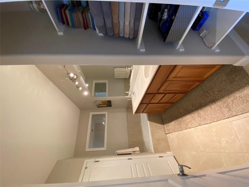 3406 Menchaca Road, Unit 24 Austin, TX 78704 - Photo 13 of 14 a spacious bathroom with a double vanity sink a mirror and a shower