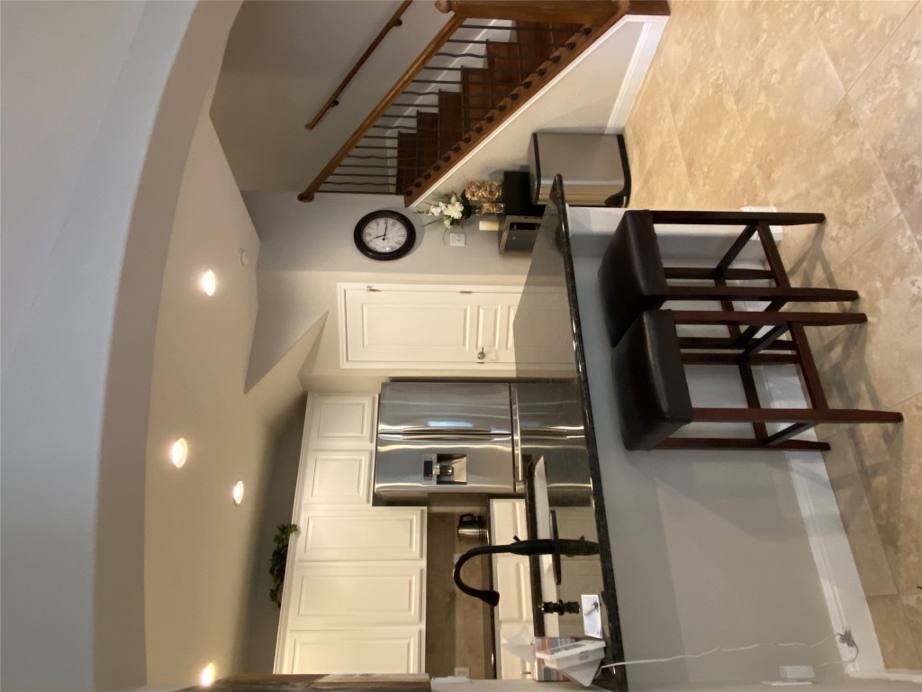 3406 Menchaca Road, Unit 24 Austin, TX 78704 - Photo 5 of 14 a kitchen with stainless steel appliances kitchen island granite countertop a sink a stove a refrigerator cabinets and chairs