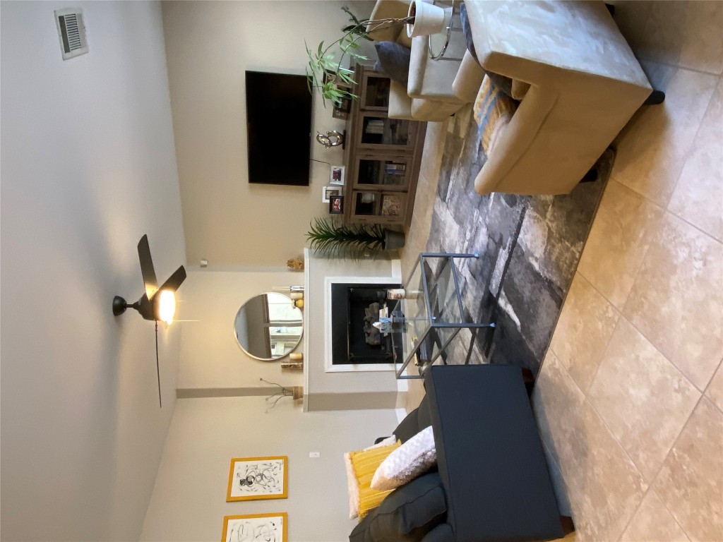3406 Menchaca Road, Unit 24 Austin, TX 78704 - Photo 7 of 14 a living room with furniture a flat screen tv and a fireplace