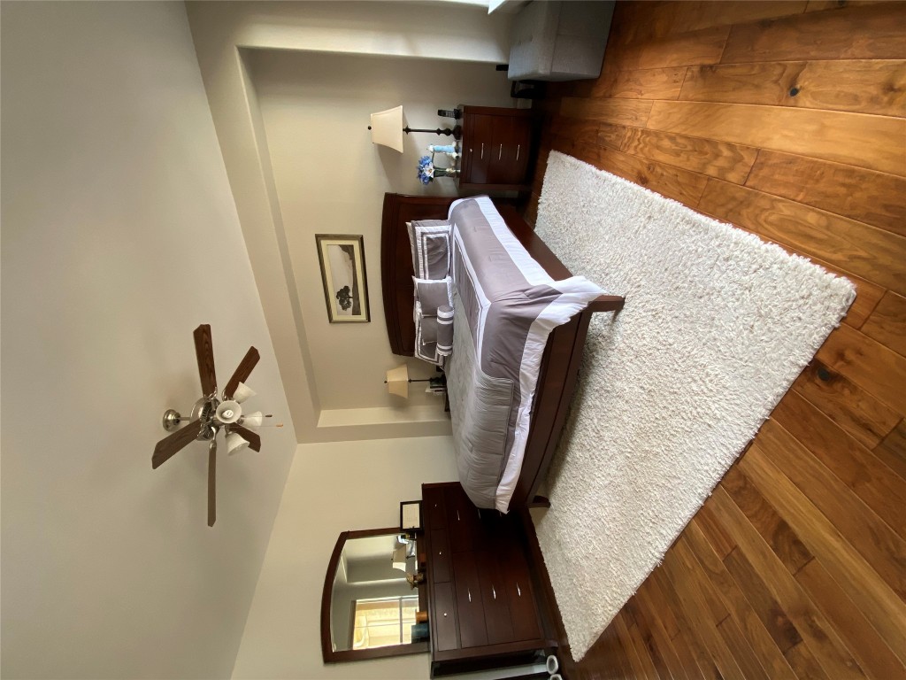 3406 Menchaca Road, Unit 24 Austin, TX 78704 - Photo 9 of 14 a bedroom with a bed and wooden floor