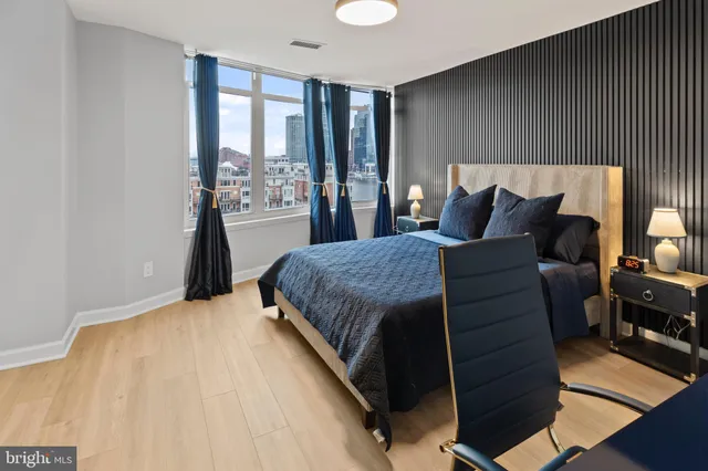 a bedroom with a bed and wooden floor