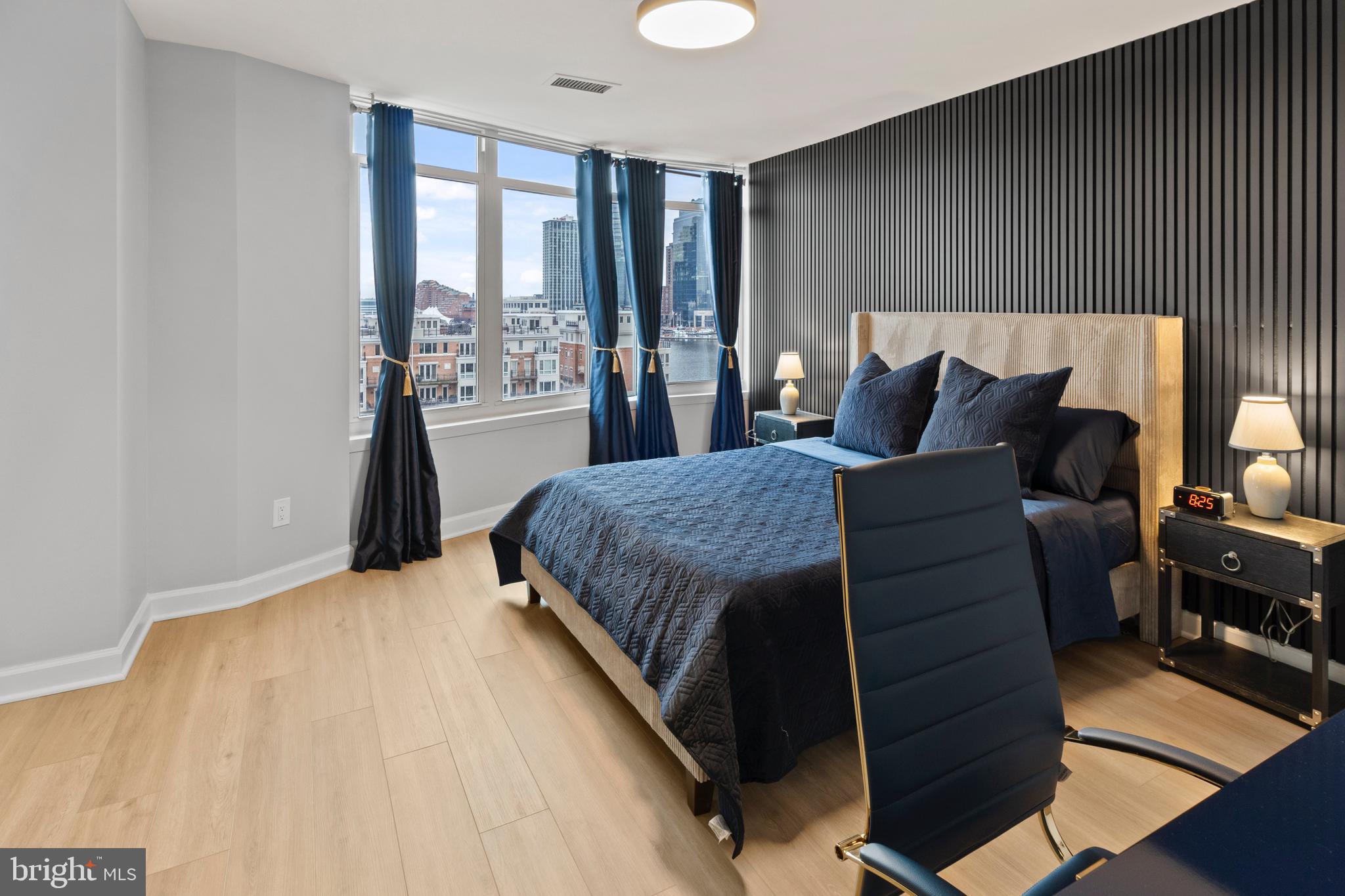 100 Harborview Drive, Unit 507 Baltimore, MD 21230 - Photo 12 of 28 a bedroom with a bed and wooden floor