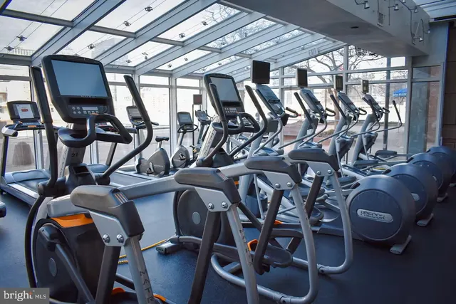 a room with gym equipment and mirrors