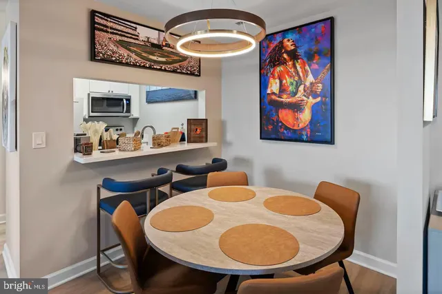 a dining room with furniture and wooden floor