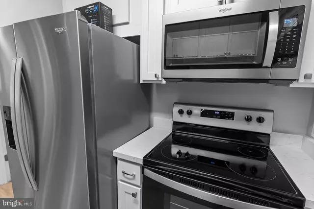 a stove top oven sitting inside of a kitchen