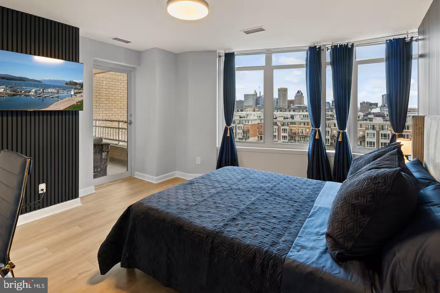 100 Harborview Drive, Unit 507 Baltimore, MD 21230 - Photo 10 of 28 a bedroom with a large bed and a large window
