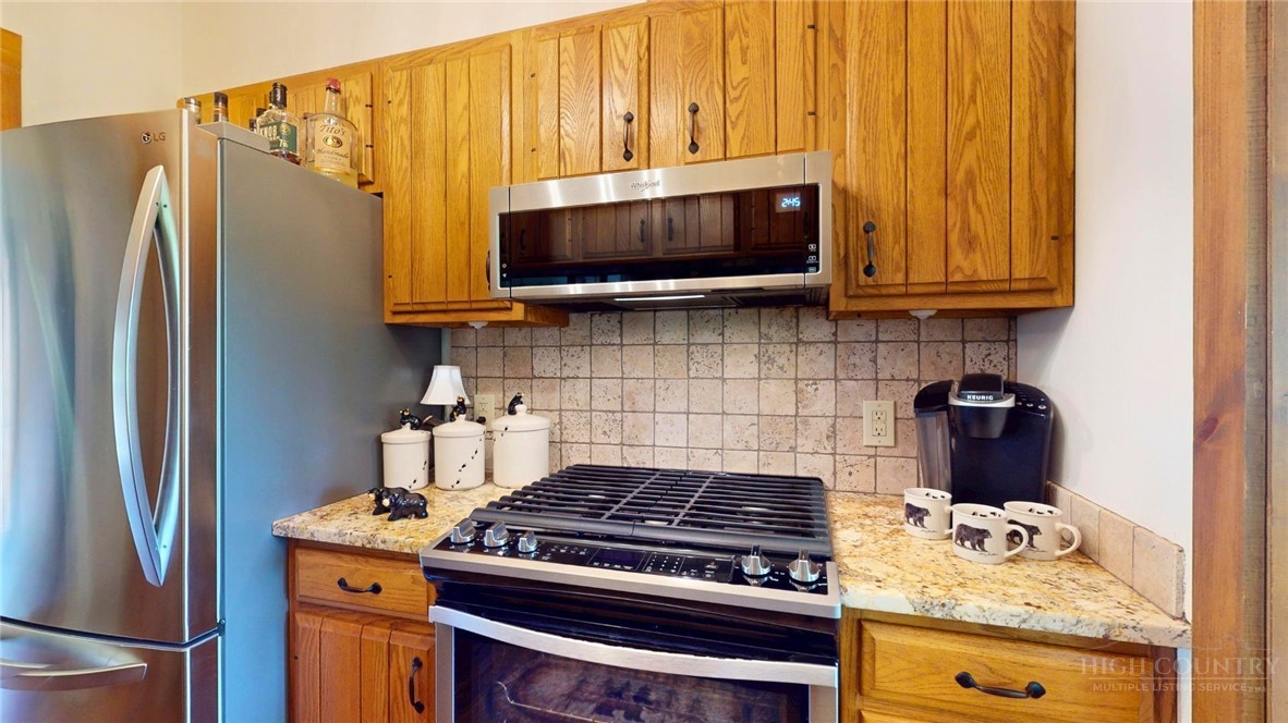 250 Ridgeview Road, Unit 43 Sugar Mountain, NC 28604 - Photo 8 of 21 a kitchen with stainless steel appliances granite countertop a stove a refrigerator and a microwave