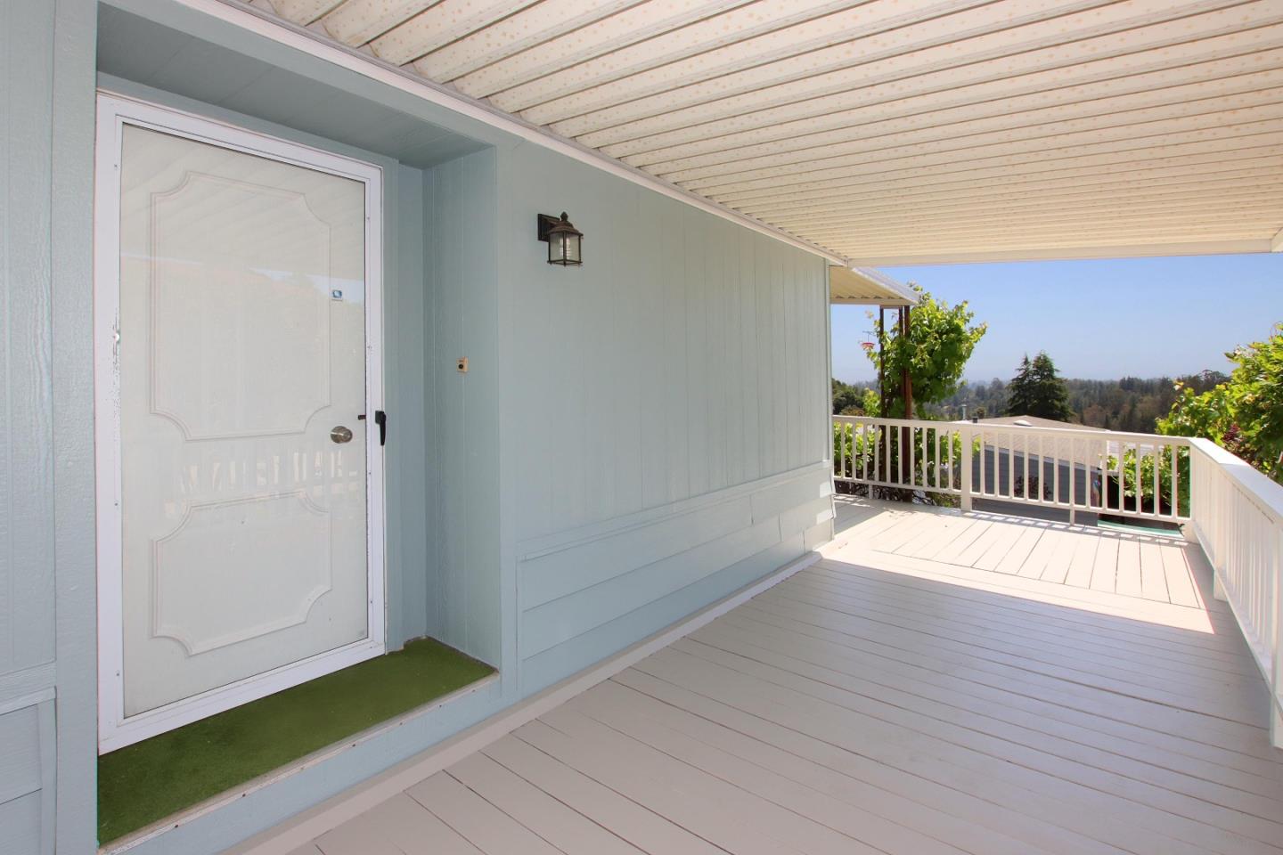 270 Hames Road, Unit 60 Corralitos, CA 95076 - Photo 3 of 32 a view of a deck with wooden floor and fence