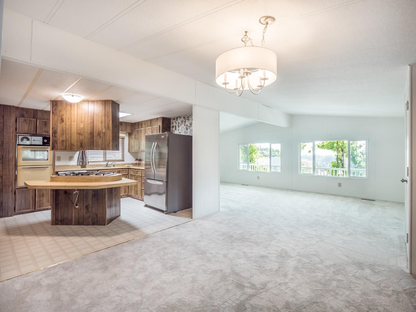 270 Hames Road, Unit 60 Corralitos, CA 95076 - Photo 4 of 32 a view of a kitchen with a sink and a refrigerator