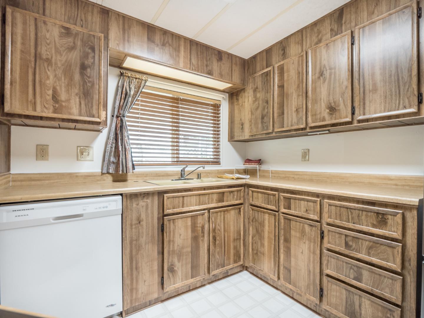 270 Hames Road, Unit 60 Corralitos, CA 95076 - Photo 7 of 32 a kitchen with granite countertop cabinets stainless steel appliances and a sink