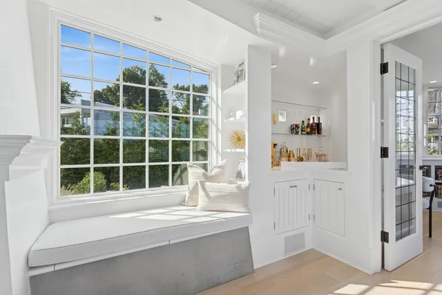 a living room with furniture cabinets and window