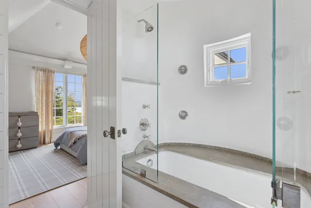 a bathroom with a tub and a shower