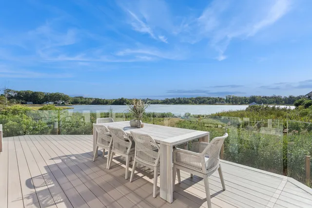 a view of a lake with furniture and city view