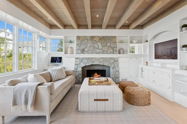 a living room with furniture fireplace and flat screen tv