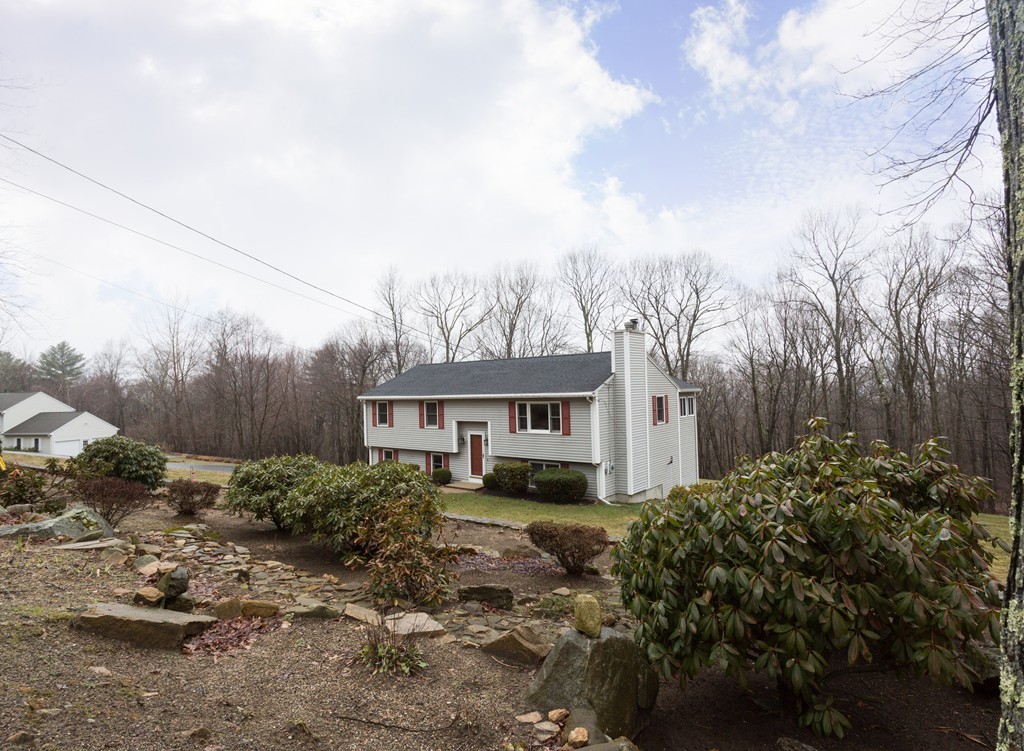 87 Hartness Road Sutton, MA 01590 - Photo 2 of 28 a house view with a garden space