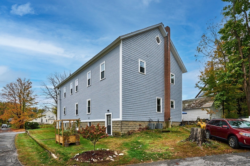 12 A Parker Avenue, Unit 1 Northfield, MA 01360 - Photo 25 of 28 a front view of a house with a yard