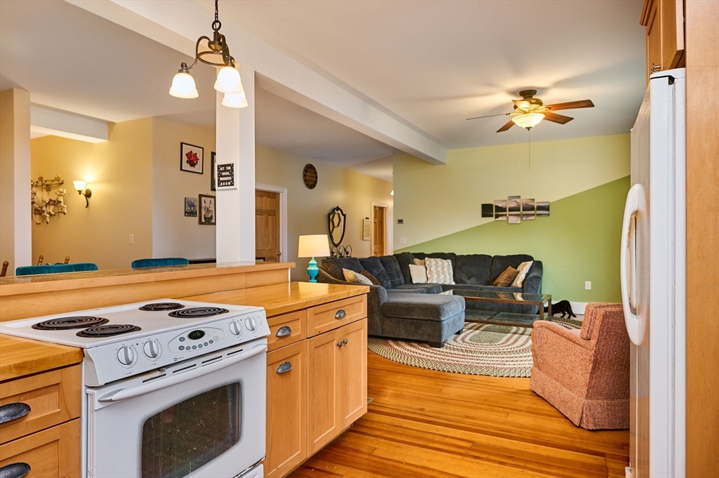 12 A Parker Avenue, Unit 1 Northfield, MA 01360 - Photo 7 of 28 a living room with fireplace furniture and a chandelier
