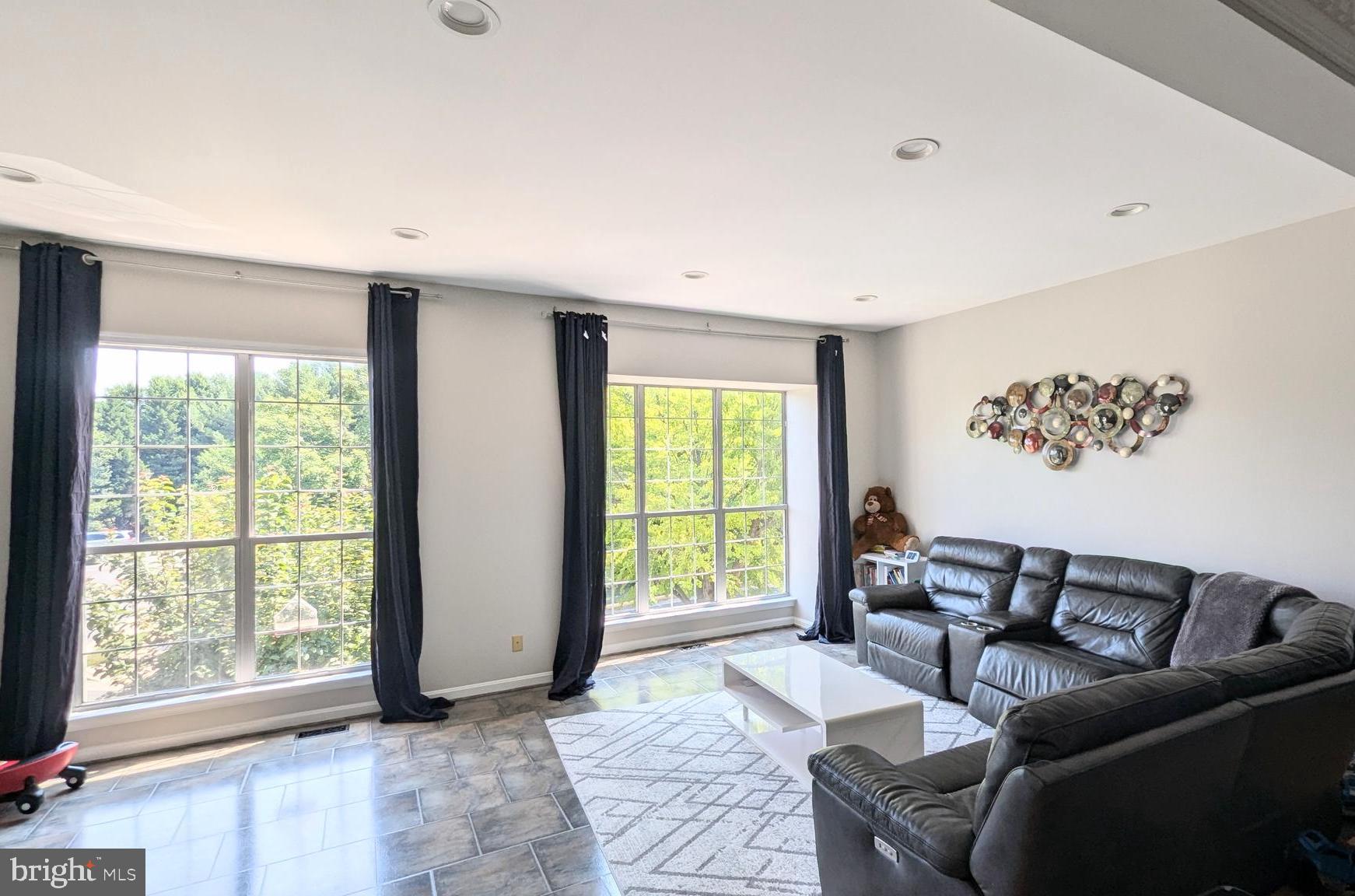 20867 Trinity Square Sterling, VA 20165 - Photo 3 of 19 a living room with furniture and a large window