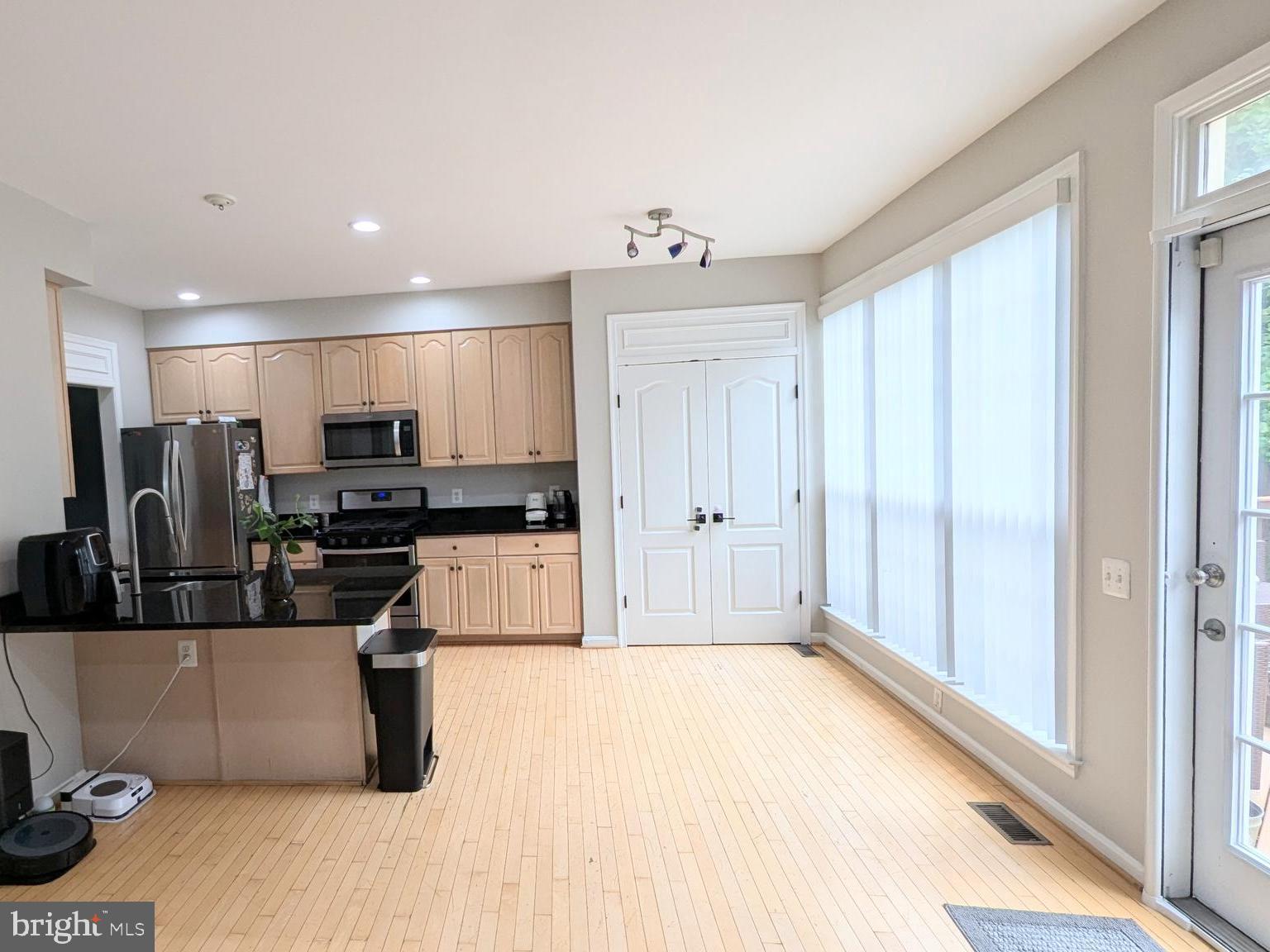 20867 Trinity Square Sterling, VA 20165 - Photo 7 of 19 a kitchen with stainless steel appliances kitchen island granite countertop a refrigerator and a sink