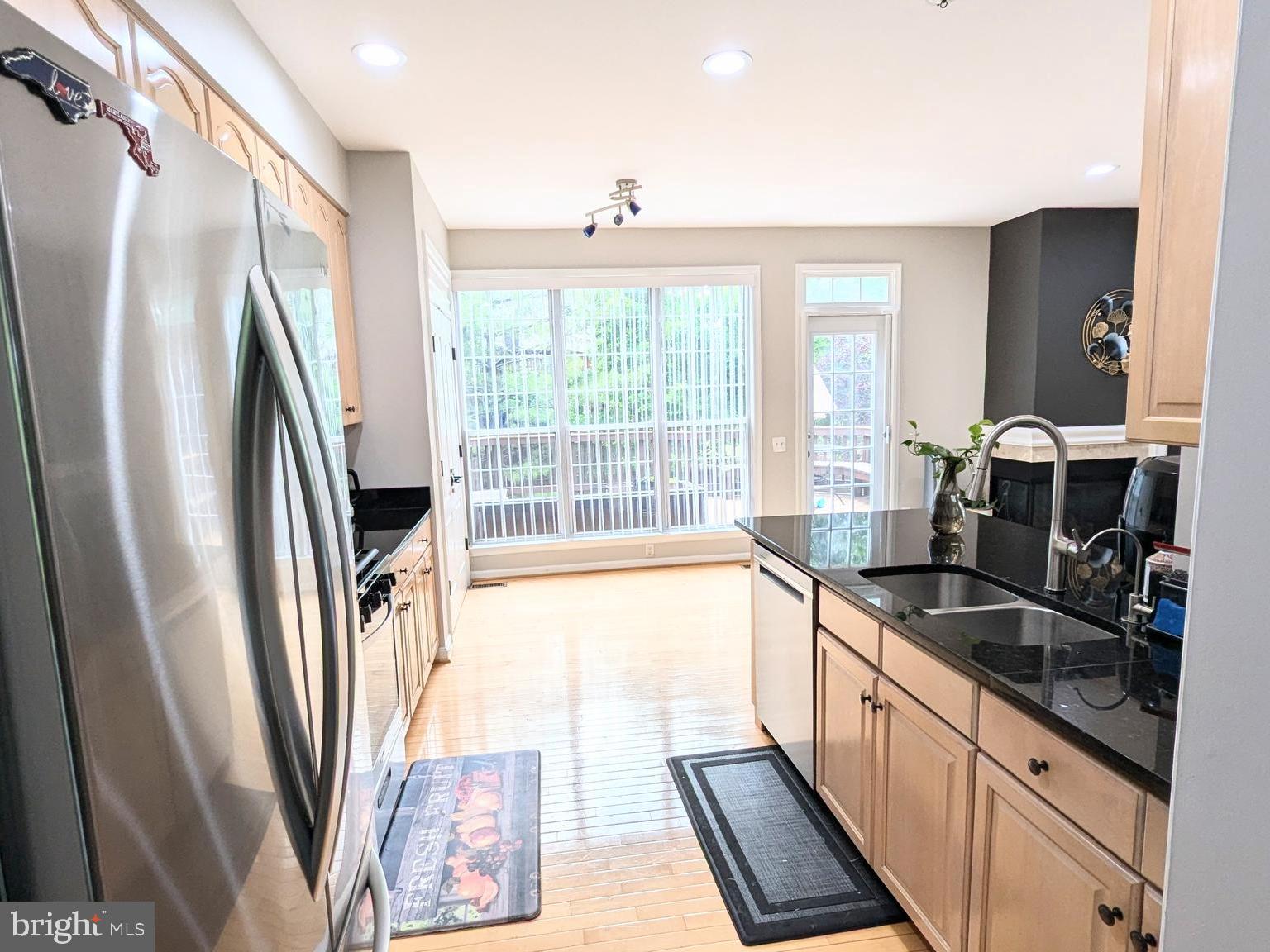 20867 Trinity Square Sterling, VA 20165 - Photo 8 of 19 a large kitchen with a sink a refrigerator and window
